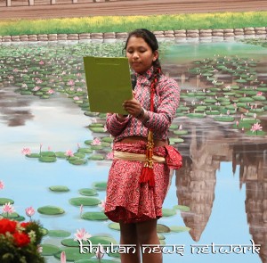 A young girl reading her poem.