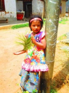 Girl playing with a plant in Bumthang